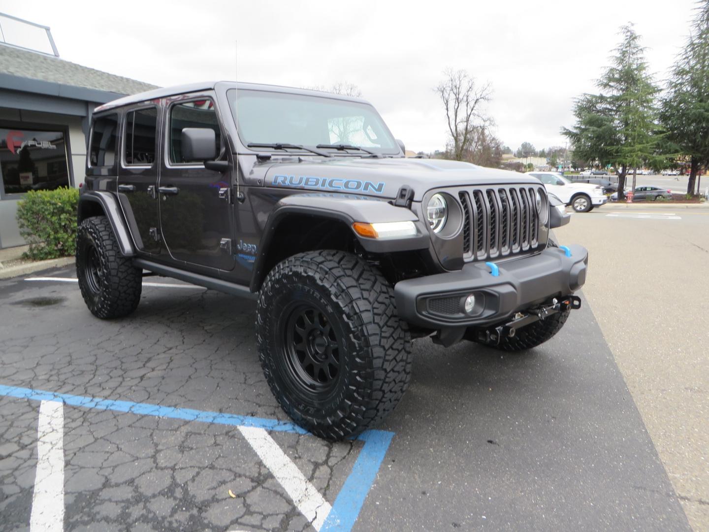 2021 CHARCOAL /BLACK Jeep Wrangler Unlimited Rubicon 4XE 4d SUV 4wd (1C4JJXR60MW) with an 2.0L L4 DOHC 16V TURBO engine, automatic transmission, located at 2630 Grass Valley Highway, Auburn, CA, 95603, (530) 508-5100, 38.937893, -121.095482 - 4XE Rubicon sitting on a Zone offroad suspension system, Fox shocks, 37" Toyo RT trail tires, 17" Method Race wheels, Teraflex Hd tire carrier, and Flat tow ready. - Photo#2